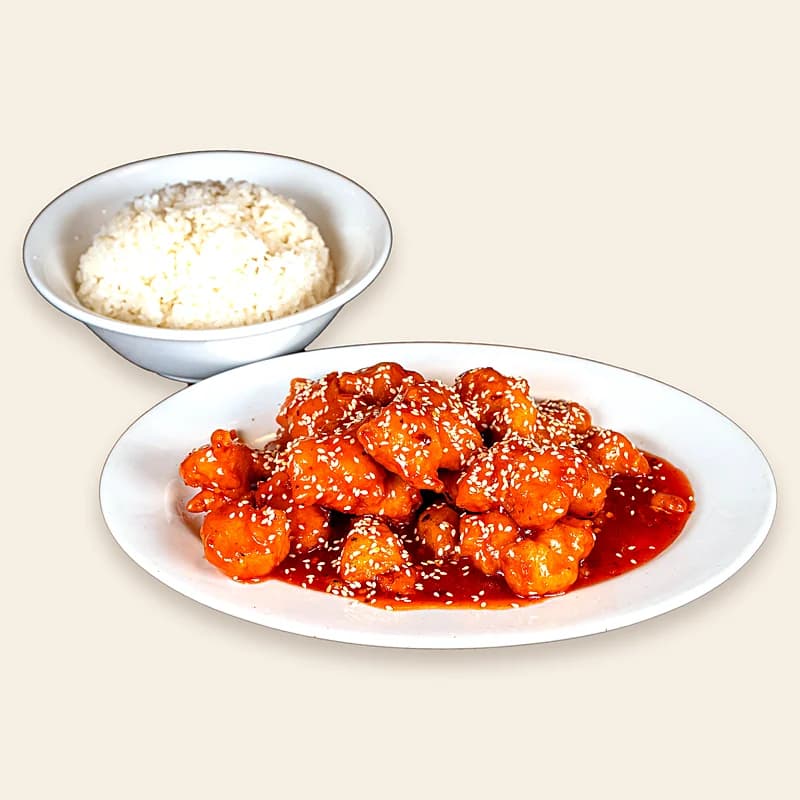 Spicy sesame chicken in a glossy red sauce with sesame seeds